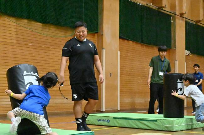 写真：真剣にタックルの練習に取り組む参加者の様子