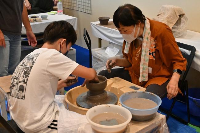 写真：ろくろで陶器を作る小学生