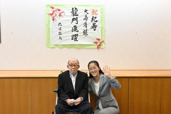 写真：大島清さんと記念写真を撮る区長
