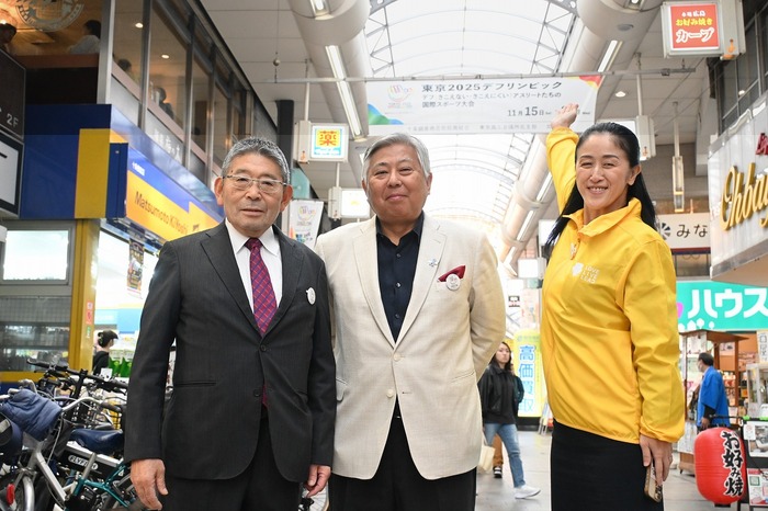 フラッグを指すやまだ北区長、上福元理事長、越野会長の写真